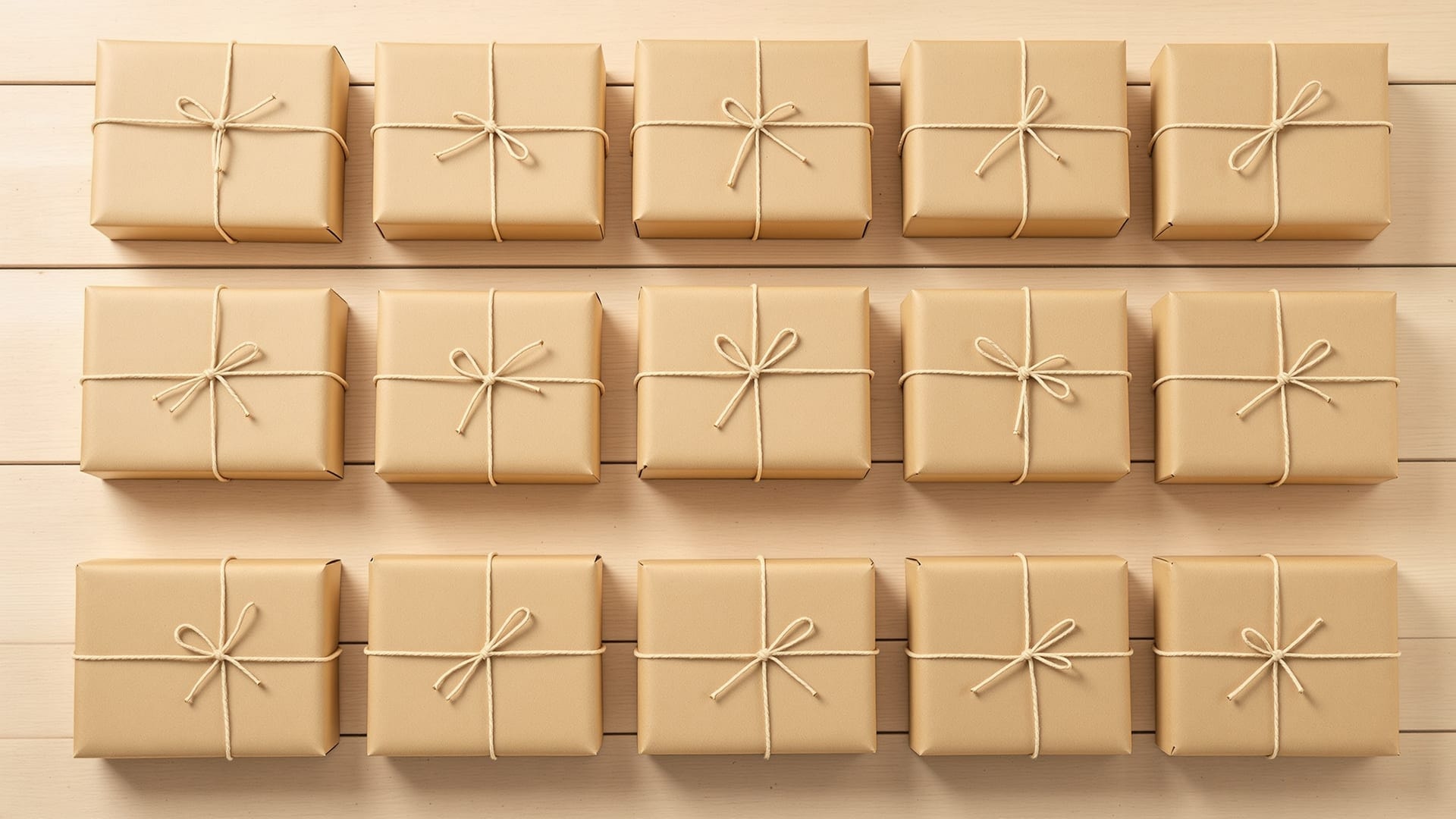 Thirteen paper-wrapped parcels arranged in a grid